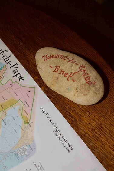 A map titled 'Appellation d'origine contrôlée' and a stone with 'Domaine de l'Isère' inscribed on it. 4