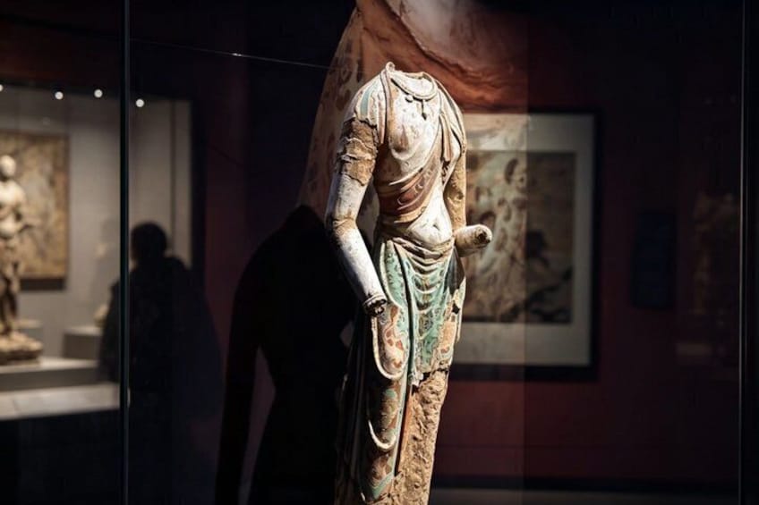 A terracotta statue in a museum. 3