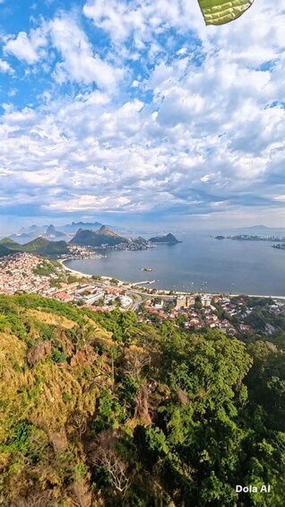 A coastal cityscape with a bay, mountains, and a partly cloudy sky. 2