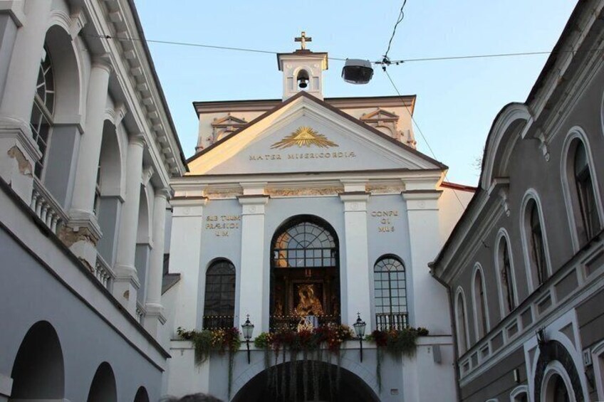 A church with a golden emblem, arched windows, and a bell tower. 3