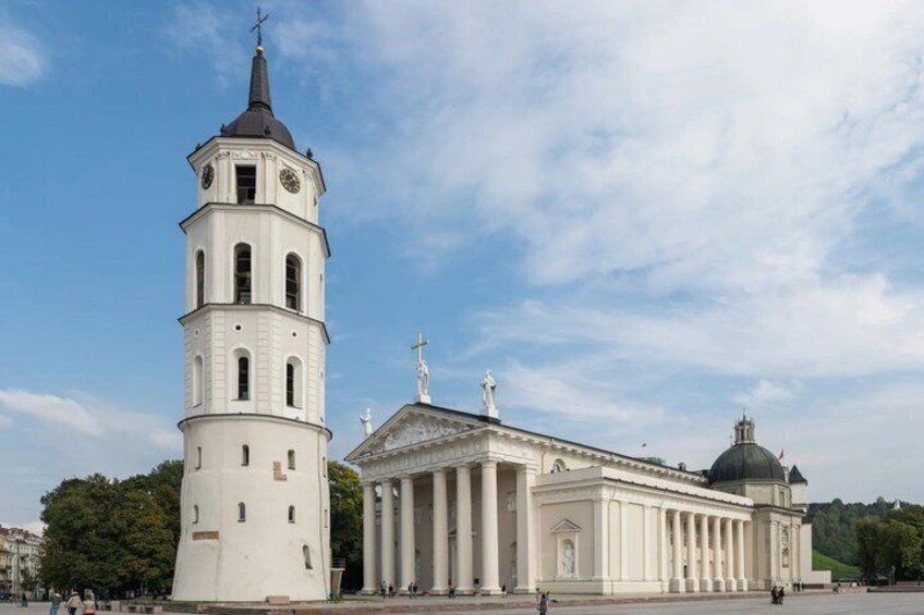 A white church with a bell tower and a dome. 4