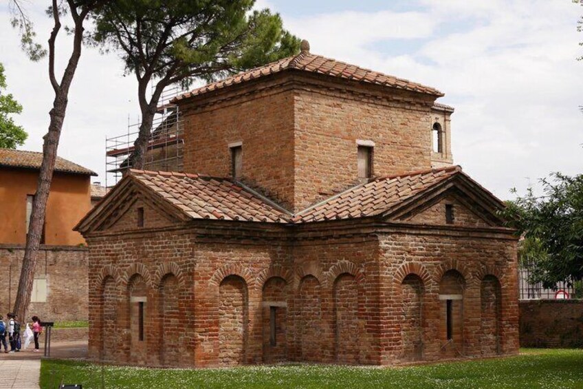 A brick building with arched windows and a tiled roof. 2