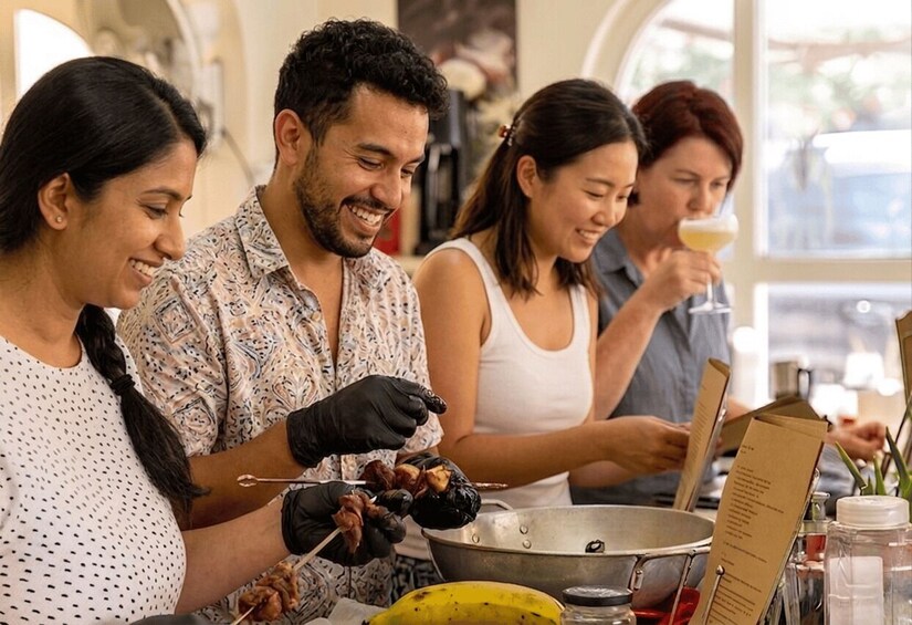 People grilling food outdoors. 1
