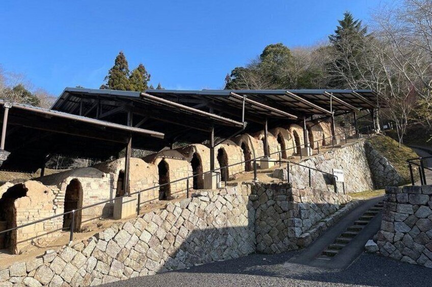 A stone staircase leading up to a covered structure with arched openings. 3