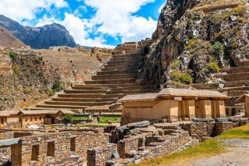 Ancient stone structures, terraced steps, and a mountainous backdrop. 5