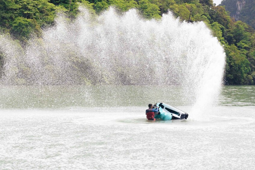 A jet ski overturned in a body of water with a large waterfall in the background. 3