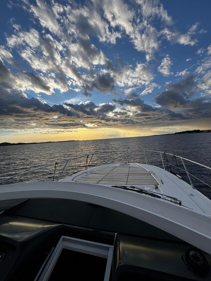 A boat deck with a view of the sea and a sunset sky. 3