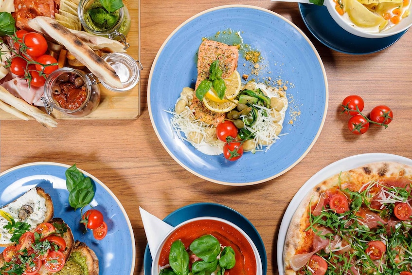 A variety of dishes including salmon, pizza, and a bowl of soup. 1