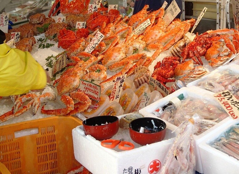 A seafood market with various types of crabs displayed on ice. 3