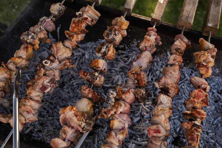 Skewers of meat grilling over charcoal. 3