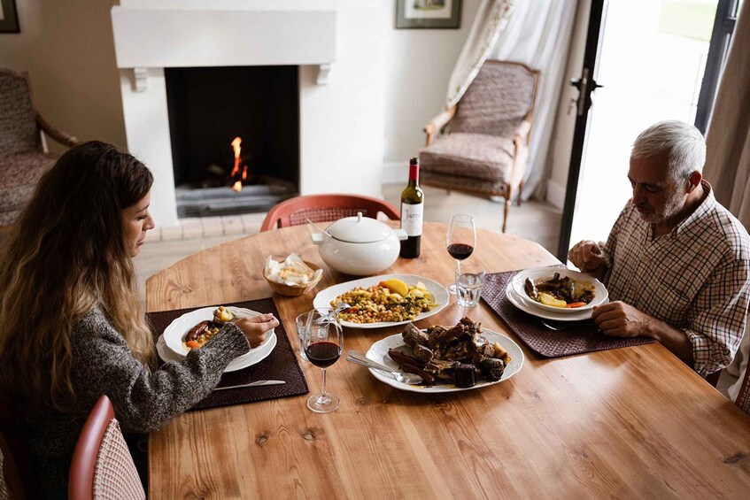A family dining at a wooden table with a fireplace in the background. 4
