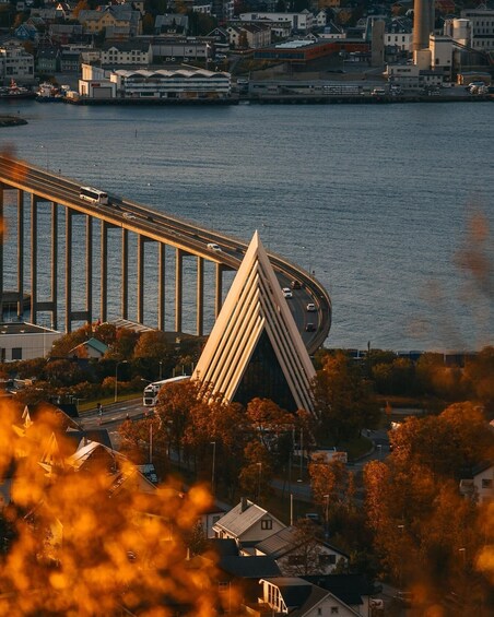 A bridge with a unique triangular structure, a waterfront, and a cityscape in the background. 5