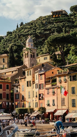A coastal town with colorful buildings, a clock tower, and a flag. 4