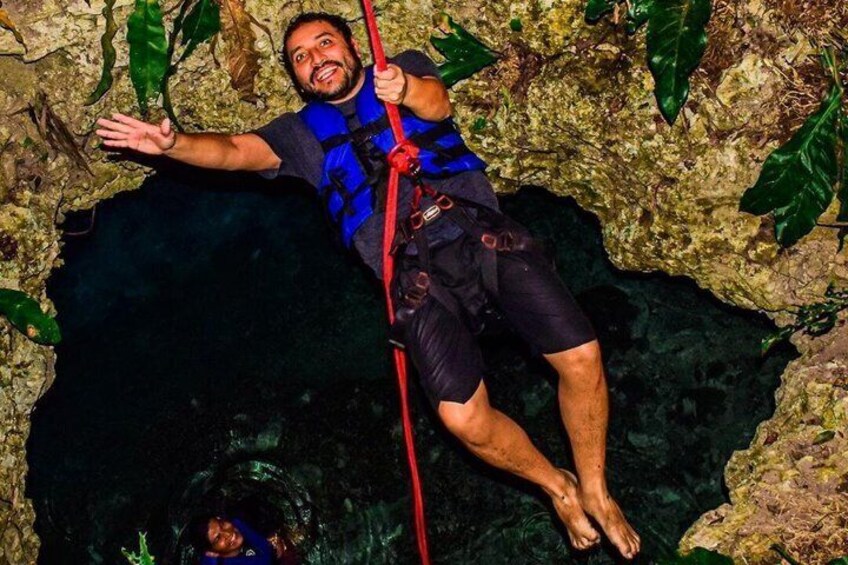 A person climbing a rocky cliff with a rope. 3