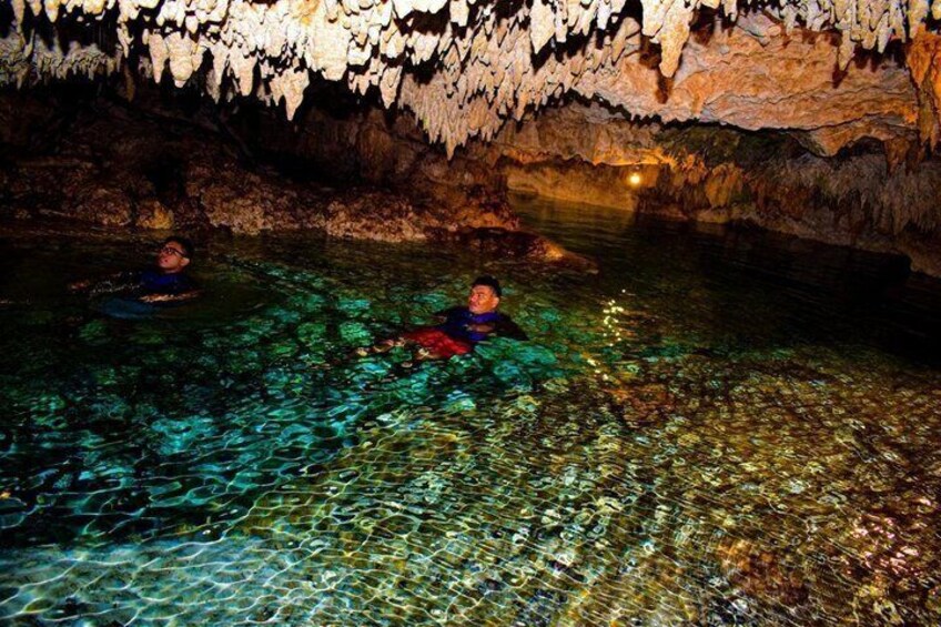 A cave with clear water and stalactites. 1