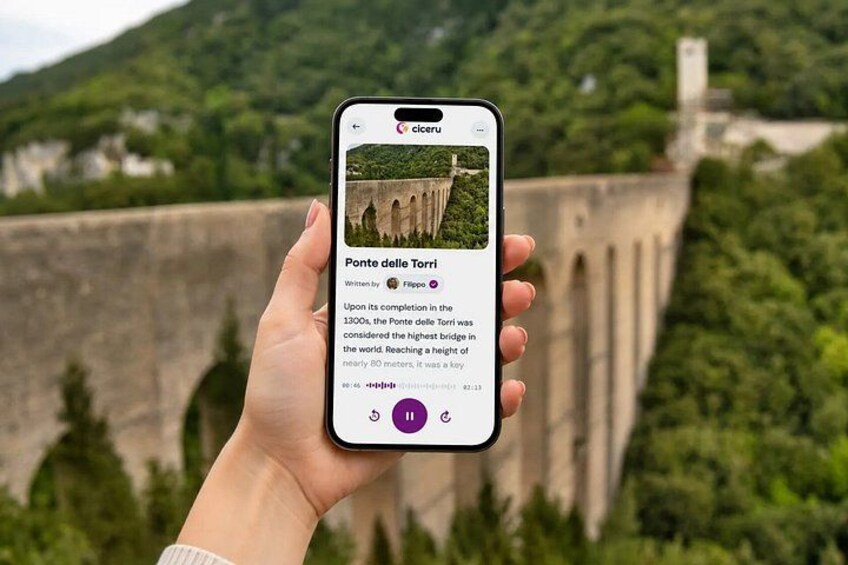 A hand holding a smartphone displaying information about the Ponte delle Torri. 1