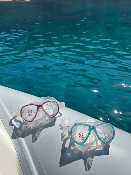 Two pairs of snorkeling gear on a boat's edge. 3