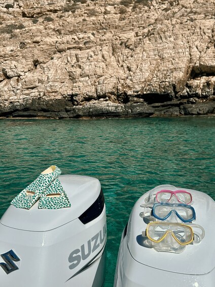 A white Suzuki boat with snorkeling gear on top. 1