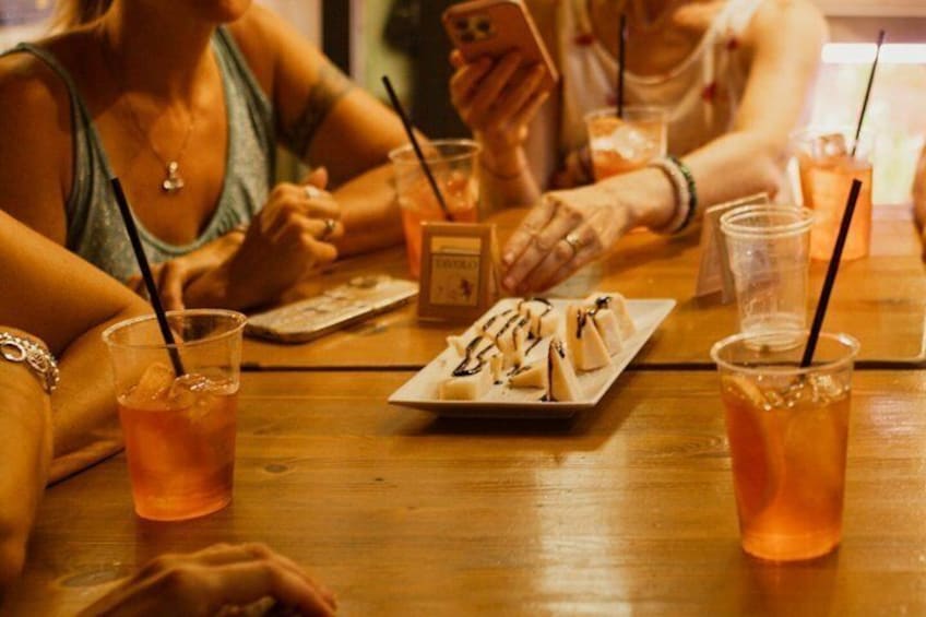 A wooden table with drinks and a dessert plate. 5