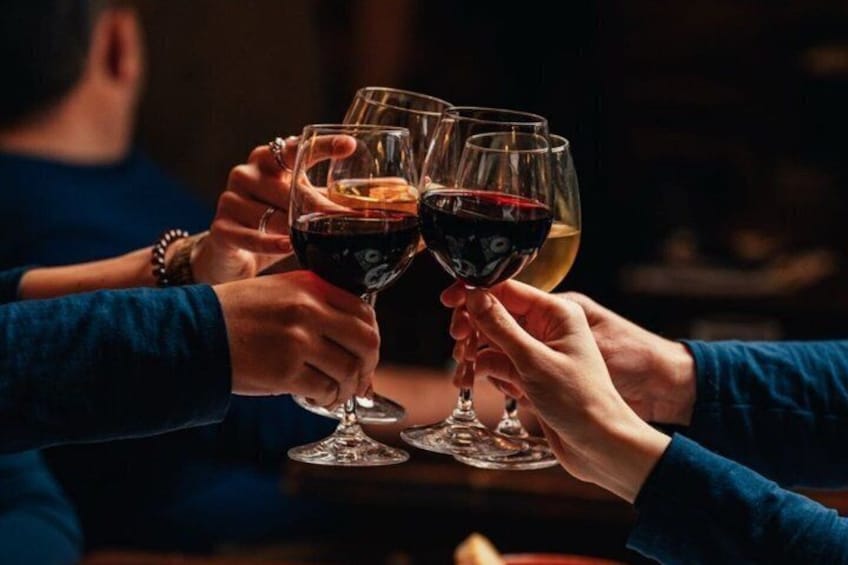 A group of people toasting with wine glasses. 1