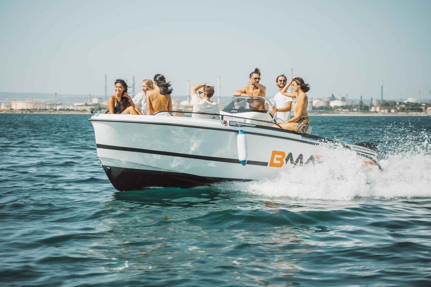 A speedboat with people on board, moving through water. 1