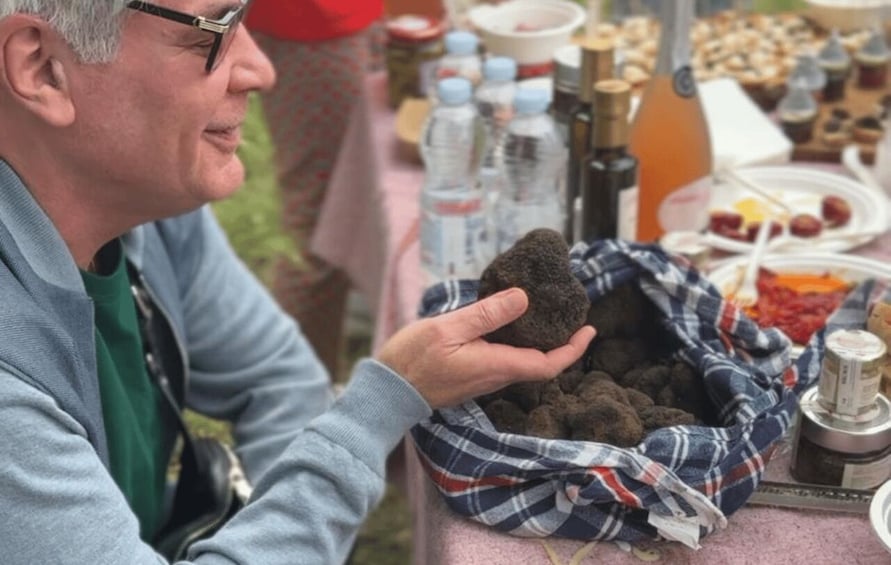 A person holding a bag of what appears to be soil or dirt. 3