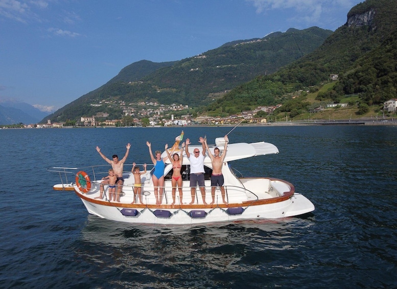 A group of people on a boat with a mountainous landscape in the background. 1