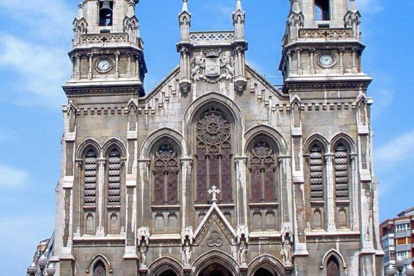 A historic cathedral with two bell towers, large arched windows, and intricate stone carvings. 4