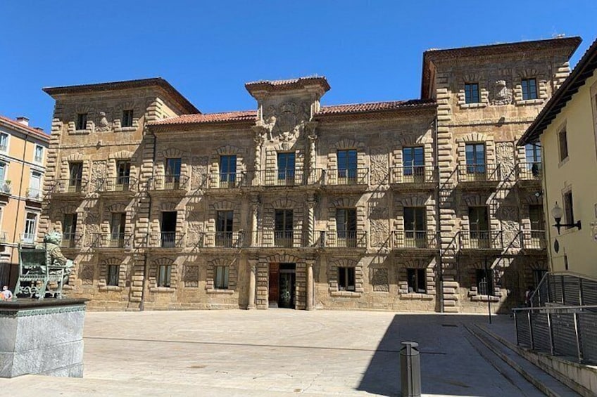 A historic building with ornate stonework and multiple balconies. 1