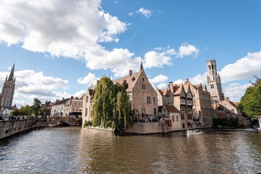 A historic town with a river, a bridge, and a tower. 5