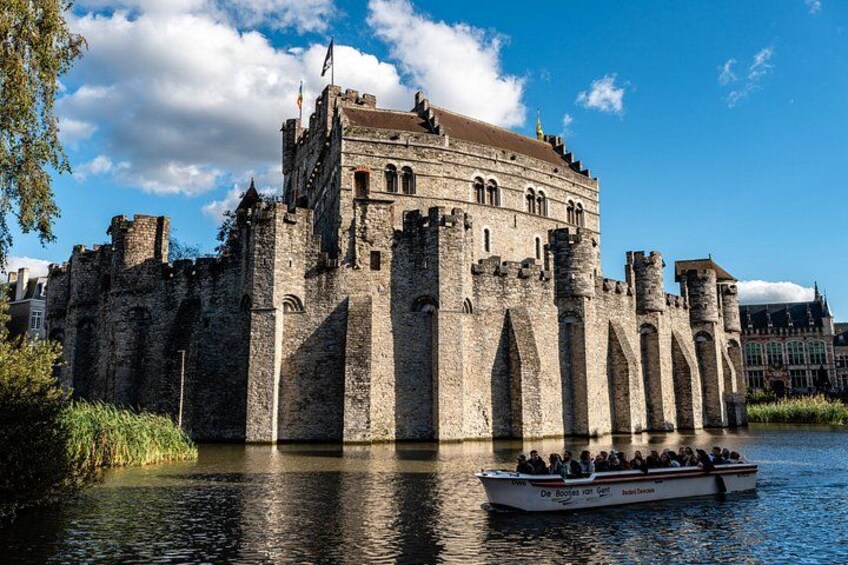 A historic castle by a river with a boat in the foreground. 5