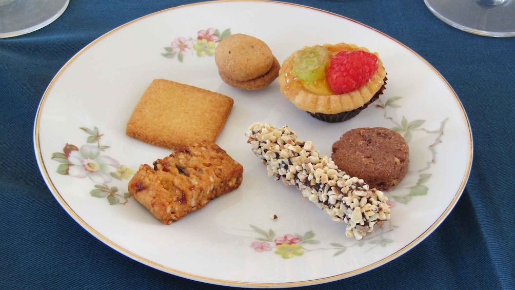 A plate with various cookies and a tart. 3