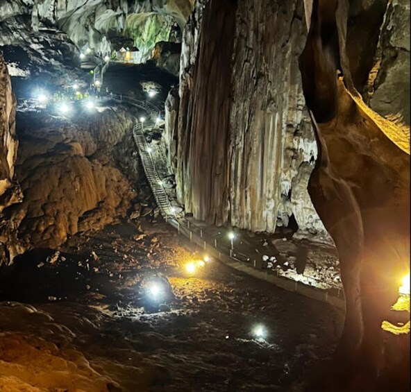 A cave with a lit pathway and a ladder. 2
