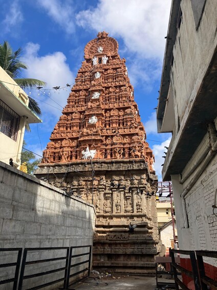 A large, intricately carved temple with multiple statues and a tiered structure. 2