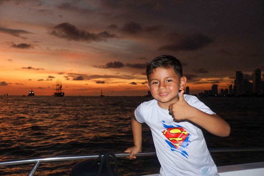 A person on a boat with a sunset and city skyline in the background. 2
