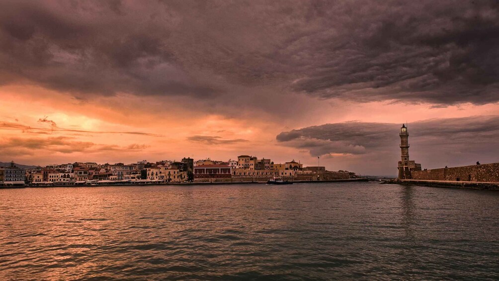 A coastal cityscape with a prominent tower and a sunset sky. 5