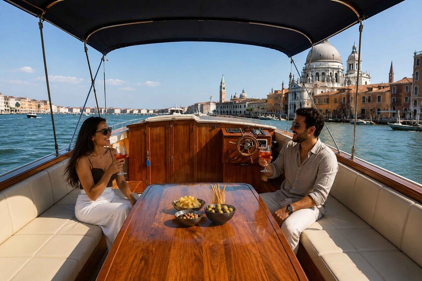 A boat with a wooden table, passengers, and a cityscape with historic buildings in the background. 4