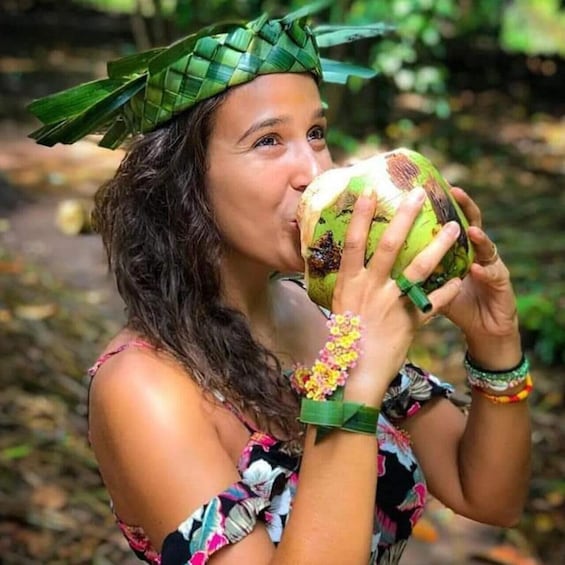 A person holding a coconut. 1