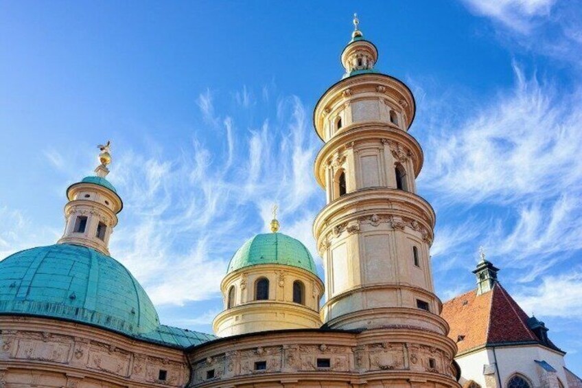 A church with multiple domes and a bell tower. 5