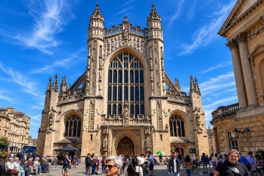 A historic cathedral with intricate architecture and a crowd of people in front. 5
