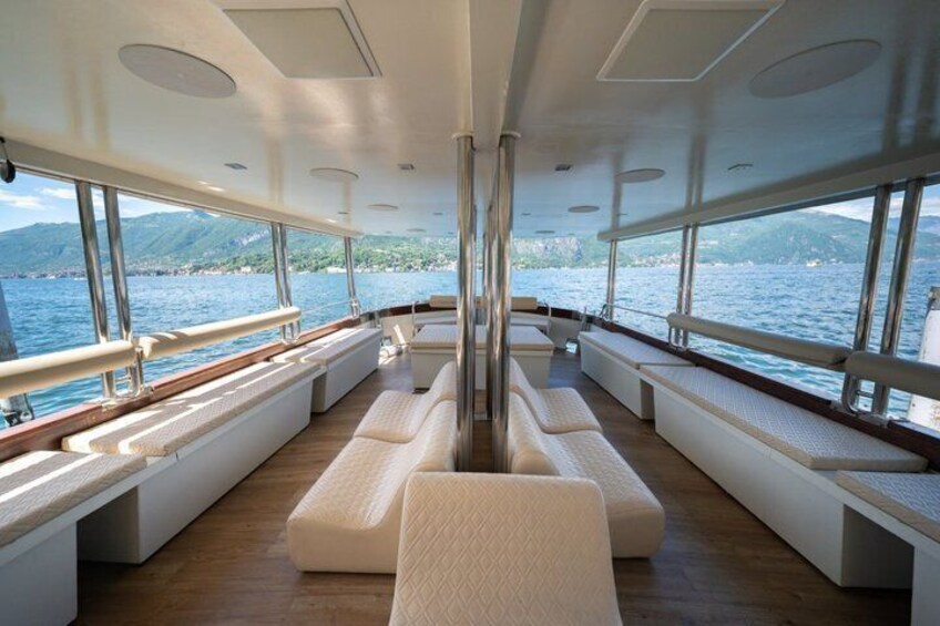 A modern interior with seating and large windows overlooking a body of water. 2