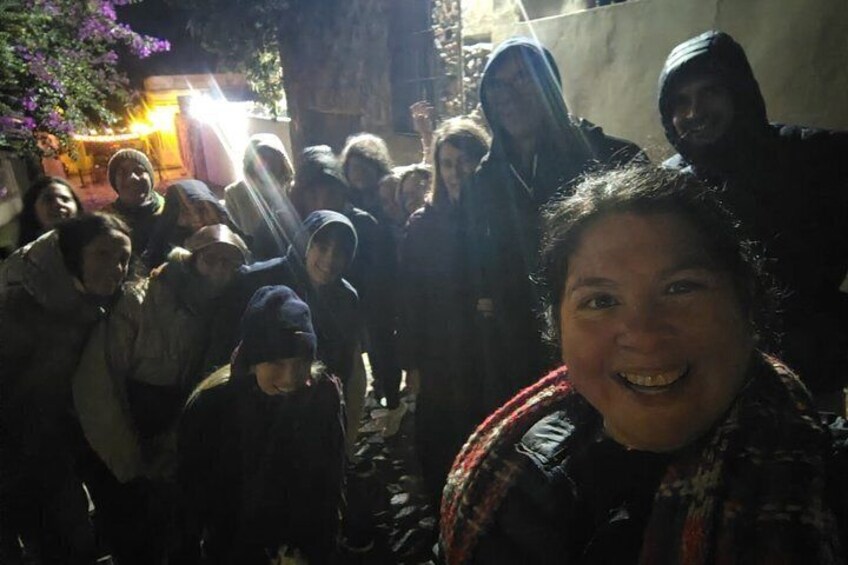 A group of people gathered in an outdoor setting at night. 3