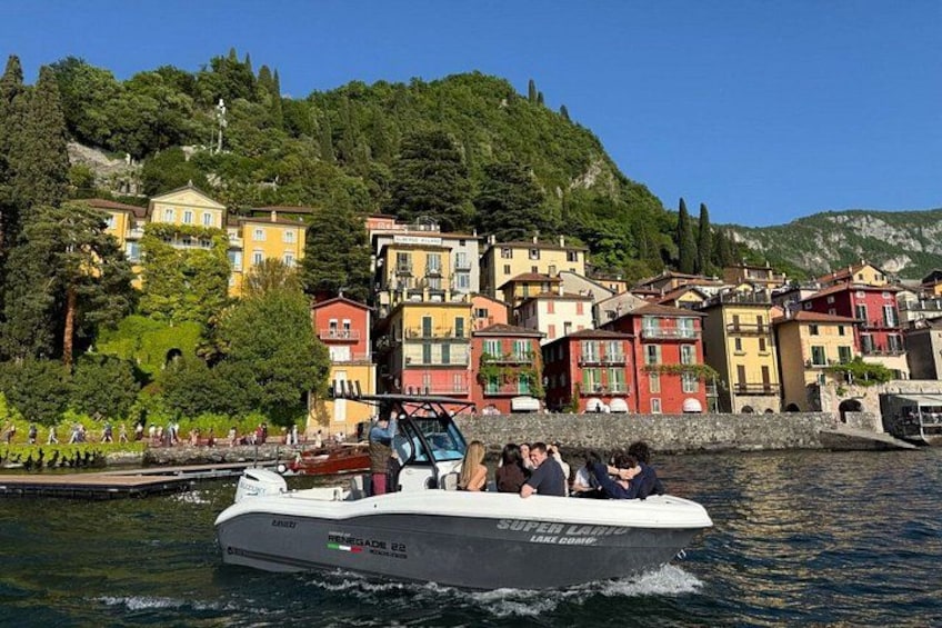 A boat on water with colorful buildings in the background. 1