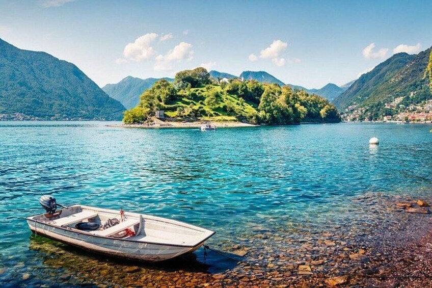A boat on a clear lake with mountains in the background. 3