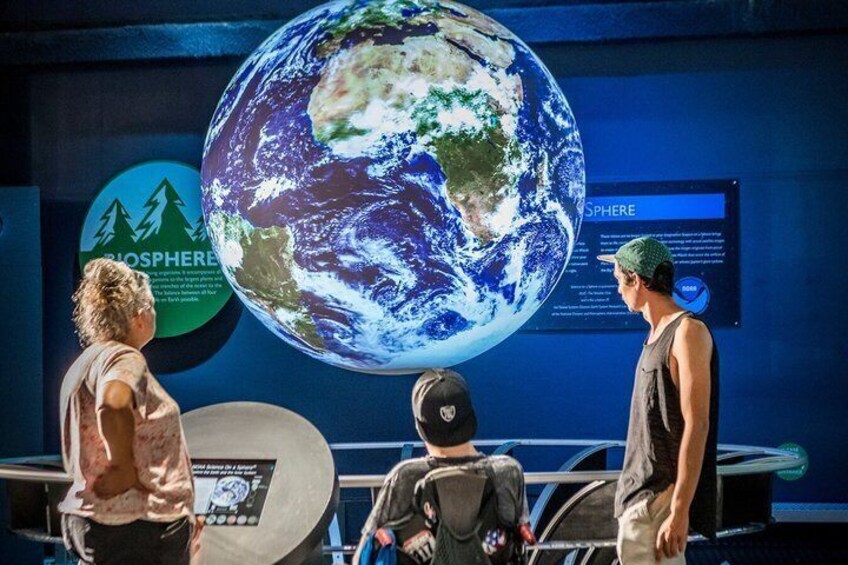 A large globe with a 'Biosphere' sign and a 'Sphere' sign in the background. 1