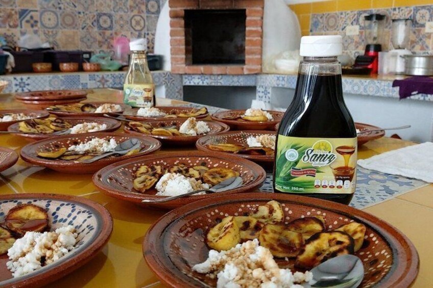 A table with traditional dishes and a bottle of Sanmiguel vinegar. 3