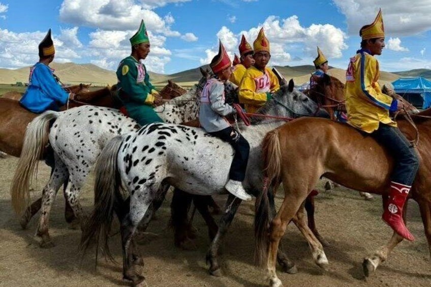 A group of people riding horses in a desert landscape. 3