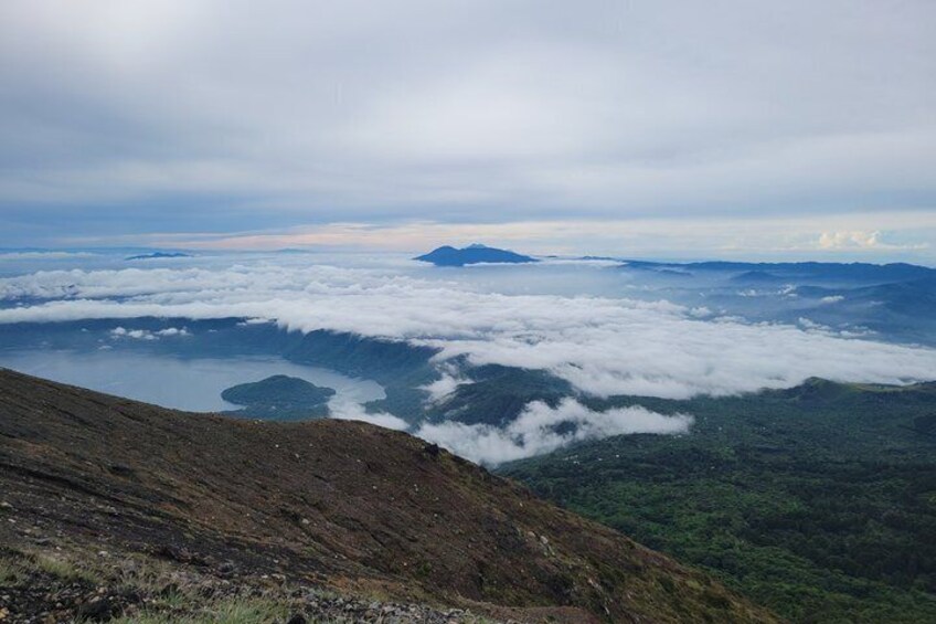 A mountain landscape with a lake and forested valley below. 3