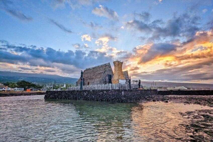 A coastal fort with a stone wall and a tower, surrounded by calm waters and a sunset sky. 3