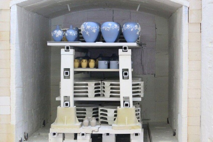 A storage area with shelves holding various ceramic items. 4